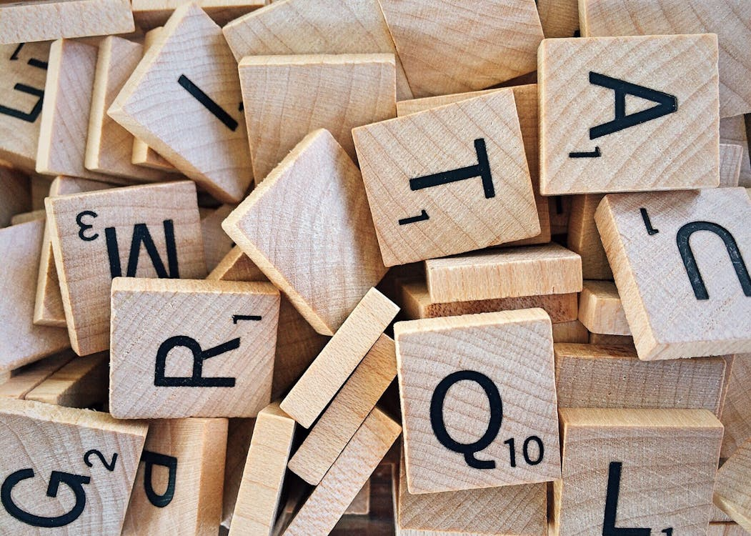 Scrabble letter tiles scattered together