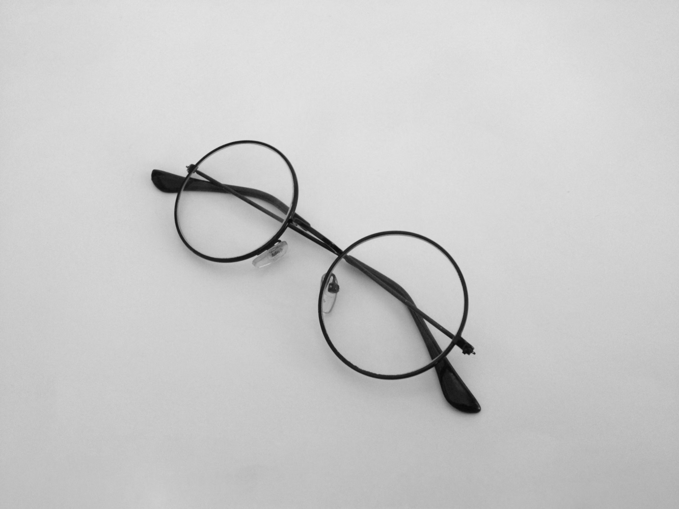 A pair of glasses on a plain surface