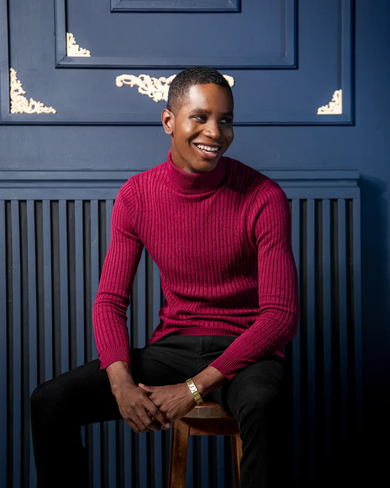 Velton Gooden Jr., seated and smiling, Jamaica-based Digital Brand Strategist.